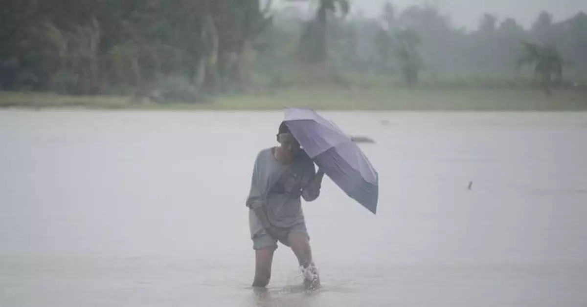 Storm blows away from northern Philippines leaving 65 dead but forecasters warn it may do a U-turn