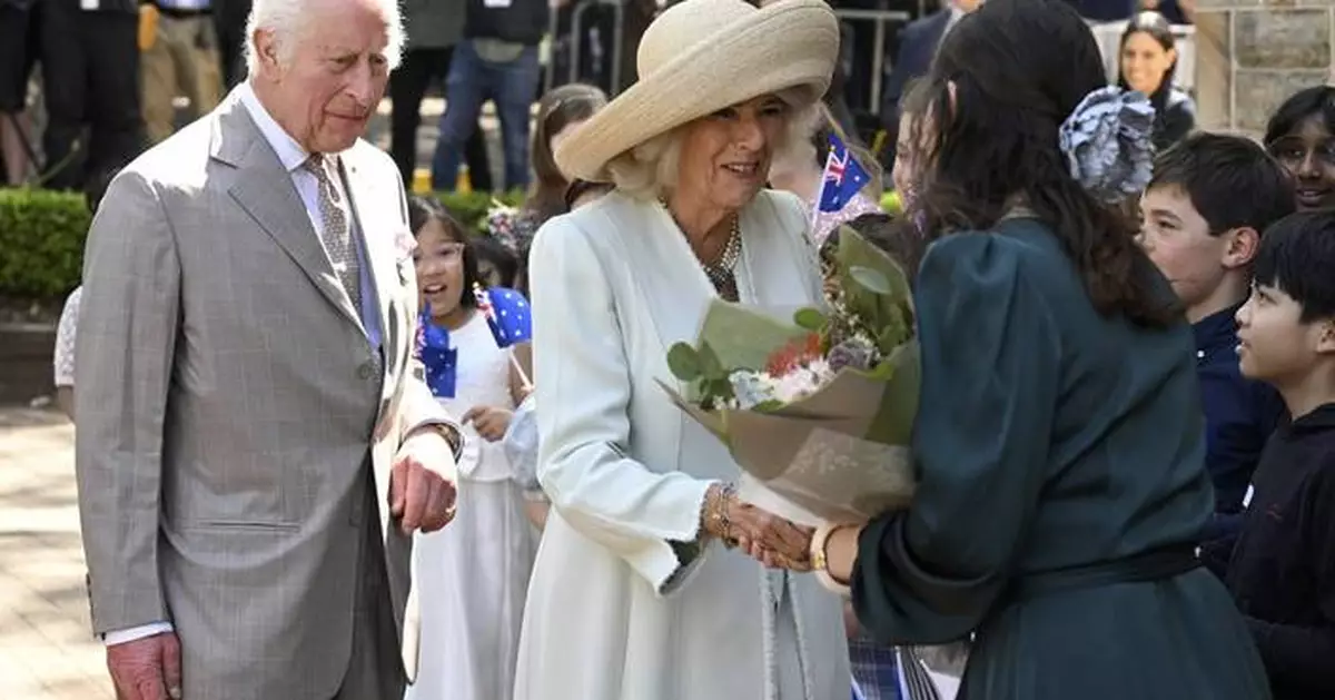 Children greet King Charles III and Queen Camilla outside a Sydney church