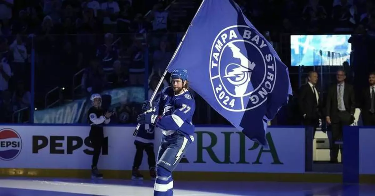 Power company workers get a standing ovation during the Lightning's hurricane-delayed home opener