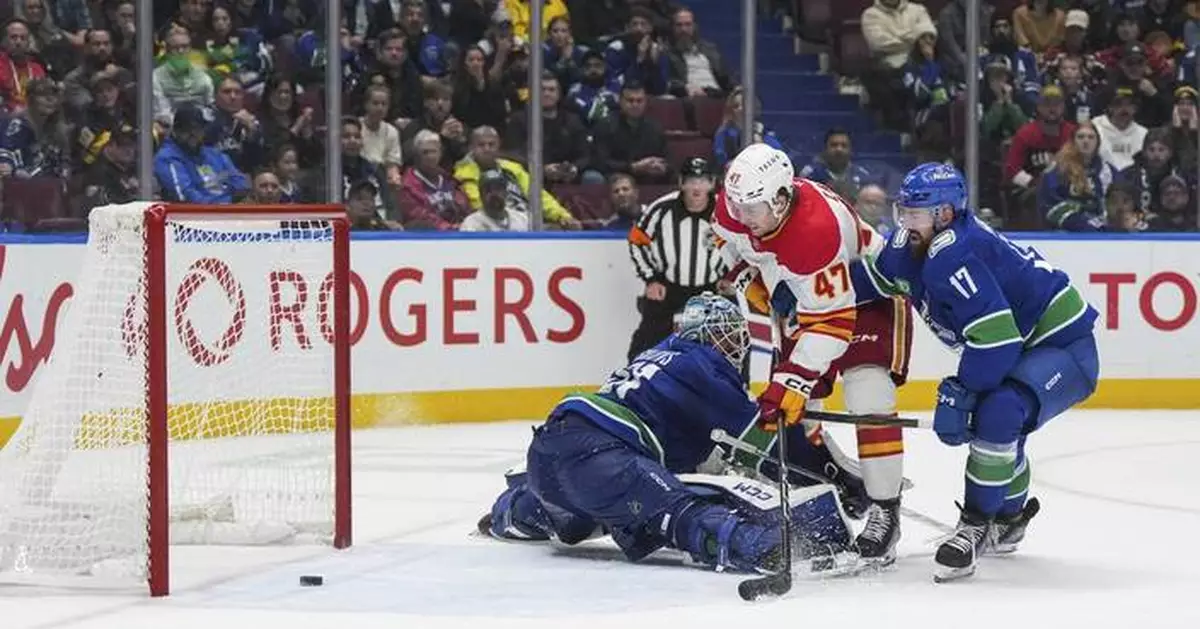 Zary scores in OT to lift Flames to 6-5 win over Canucks