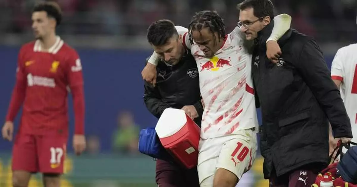 Leipzig's Xavi Simons helped off the field with injury in Champions League