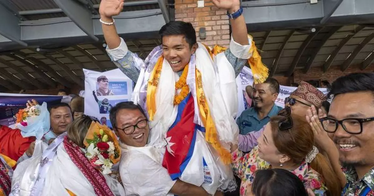 A record-setting teen climber returns home to Nepal to a hero's welcome