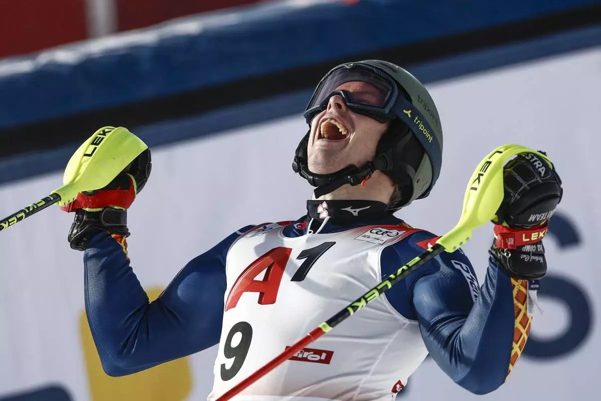 Sweden's Kristoffer Jakobsen celebrates at the finish area of an alpine ski, men's World Cup slalom, in Gurgl, Austria, Sunday, Nov. 24, 2024. (AP Photo/Gabriele Facciotti)