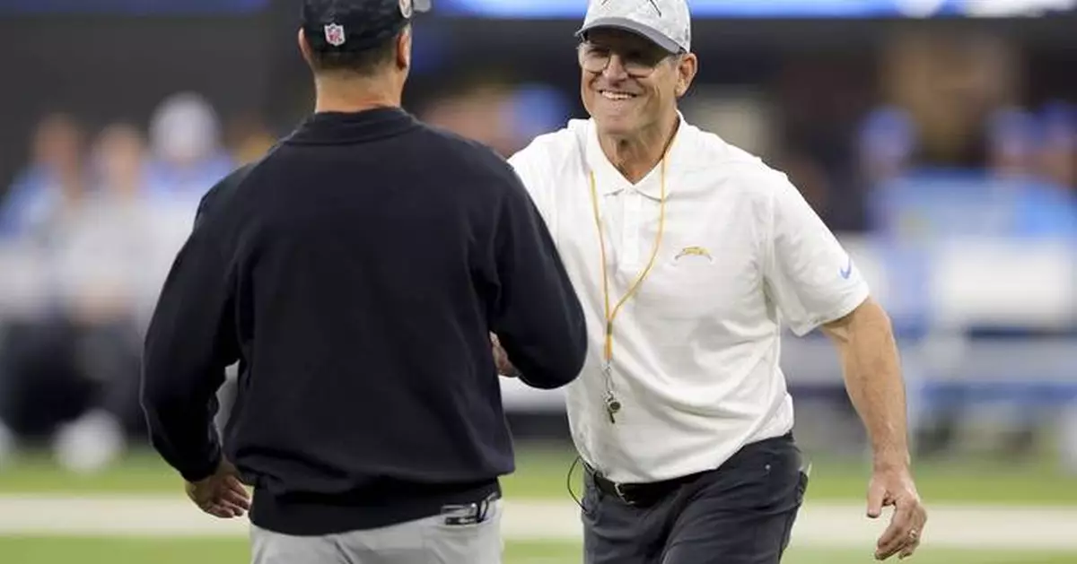 Harbaugh brothers share hug at midfield before facing each other for 3rd time