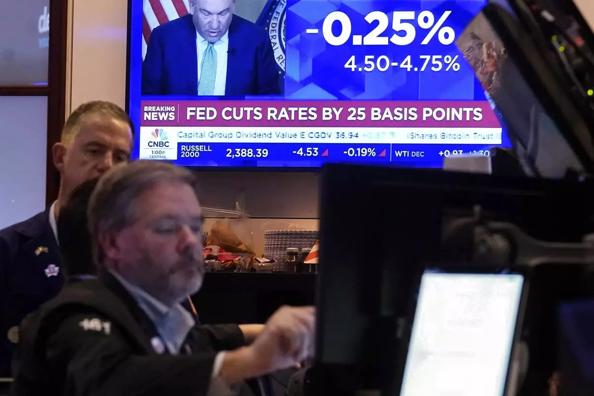 A screen on the floor of the New York Stock Exchange shows the Federal Reserve rate decision, Thursday, Nov. 7, 2024. (AP Photo/Richard Drew)