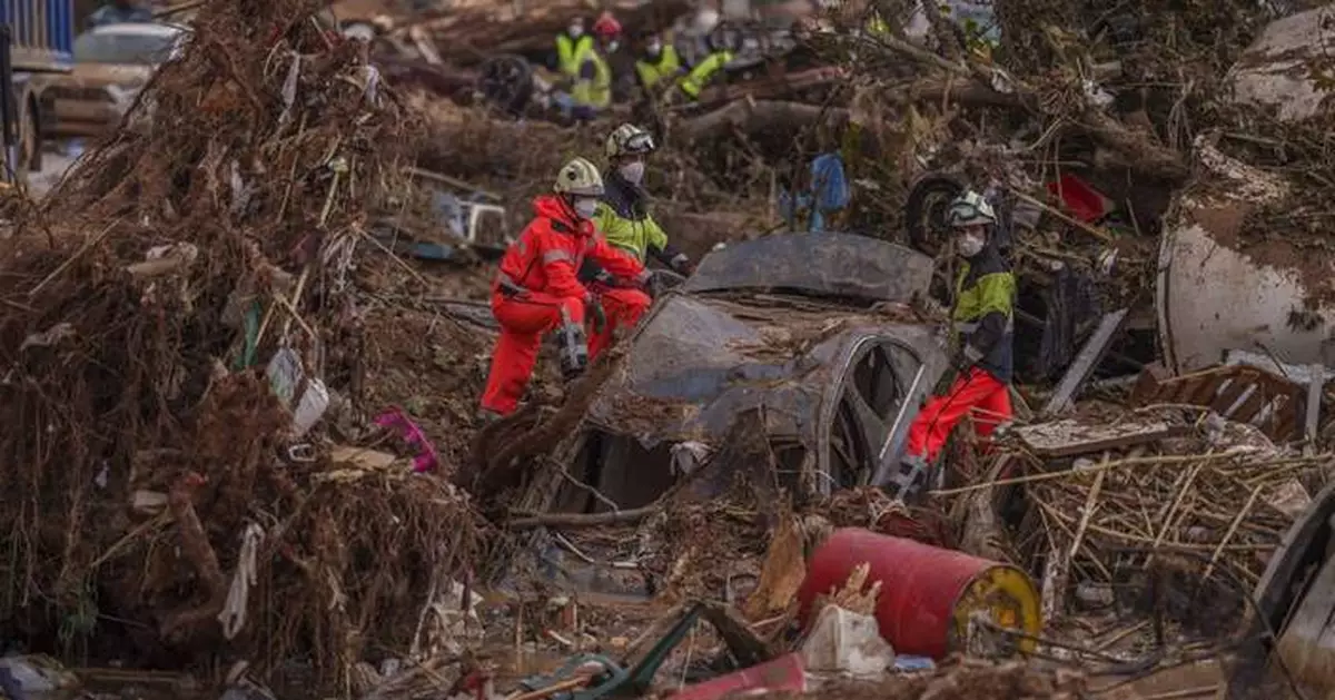 Heavy rains in Barcelona disrupt rail service as troops search for more flood victims in Valencia