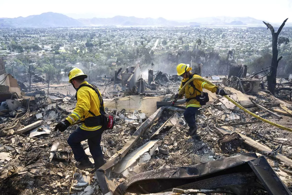 La Habra firefighters work hotspots from the Mountain Fire along West Highland Drive, Thursday, Nov. 7, 2024, in the hills of Camarillo, Calif. (Sarah Reingewirtz/The Orange County Register via AP)