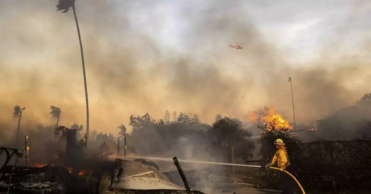 Firefighters advance on destructive blaze in California, aided by slower winds