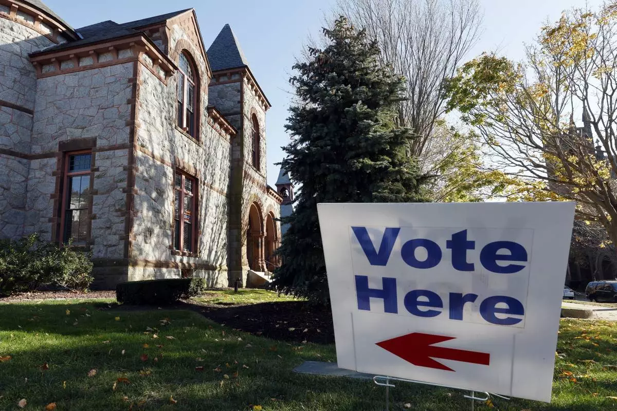 A "Vote Here" sign indicates the polling place at the Town Hall on Election Day, Tuesday, Nov. 5, 2024, in Bristol, R.I. (AP Photo/Michael Dwyer)