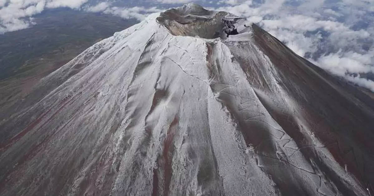 It's not official yet but Mount Fuji gets its trademark snowcap after the longest delay in 130 years