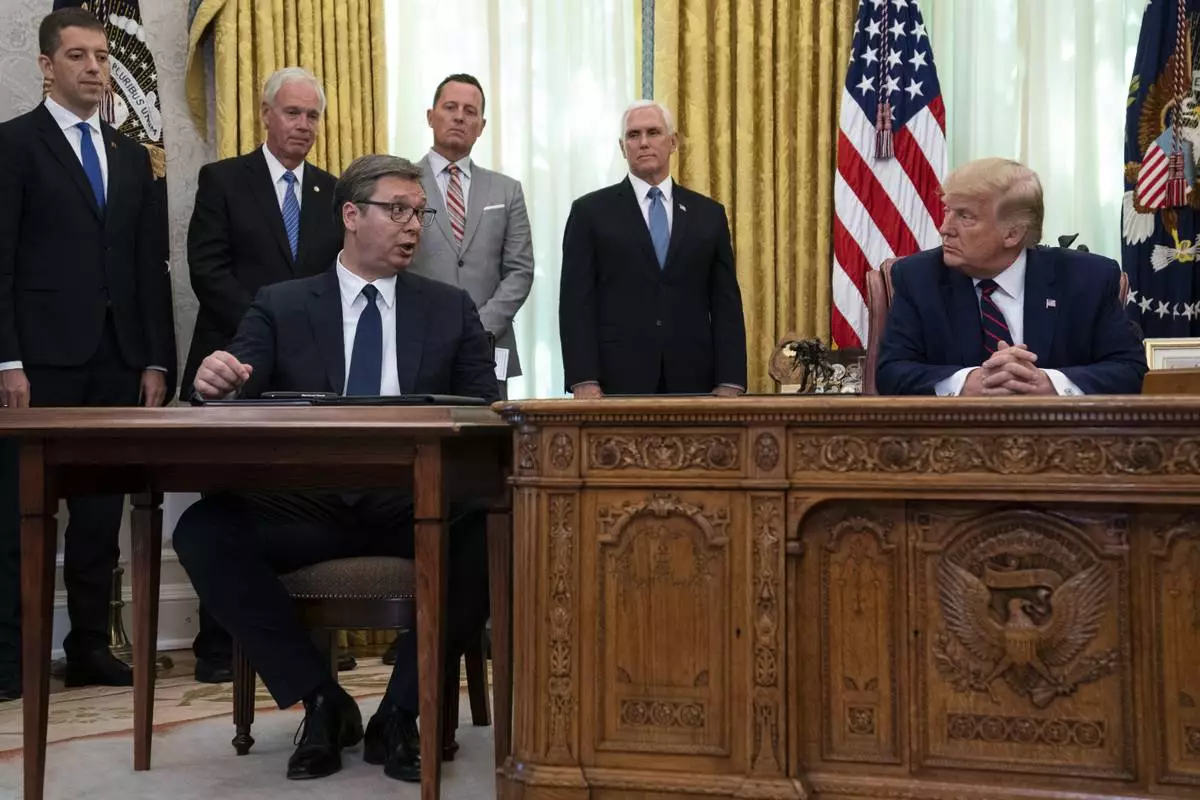 FILE - President Donald Trump listens to Serbian President Aleksandar Vucic speak during a signing ceremony with Kosovar Prime Minister Avdullah Hoti, in the Oval Office of the White House, Friday, Sept. 4, 2020, in Washington. (AP Photo/Evan Vucci, File)