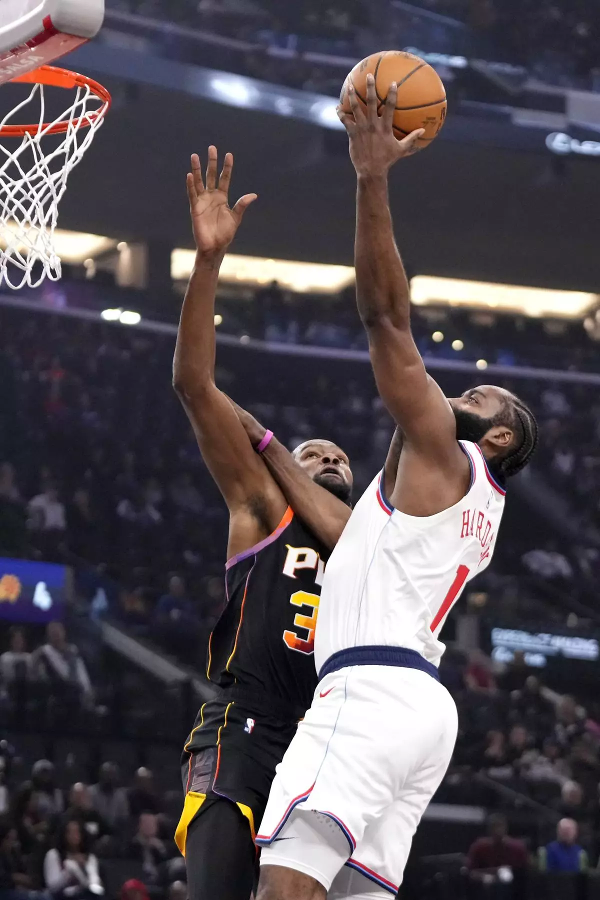 Los Angeles Clippers guard James Harden, right, shoots as Phoenix Suns forward Kevin Durant defends during the first half of an NBA basketball game, Thursday, Oct. 31, 2024, in Inglewood, Calif. (AP Photo/Mark J. Terrill)