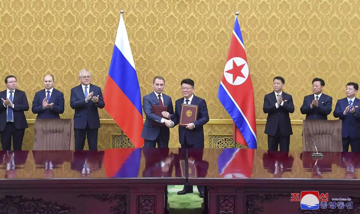 In this photo provided by the North Korean government, North Korea’s Foreign Minister of Economic Affairs Yoon Chung-ho, center right and Russia’s minister of natural resources and ecology Alexandr Kozlov, center left, shake hands at the signing ceremony of the protocol of the 11th meeting of the North Korea-Russia Intergovernmental Committee on Trade, Economy and Science and Technology Cooperation at Pyongyang , North Korea, Wednesday, Nov. 20, 2024. Independent journalists were not given access to cover the event depicted in this image distributed by the North Korean government. The content of this image is as provided and cannot be independently verified. Korean language watermark on image as provided by source reads: "KCNA" which is the abbreviation for Korean Central News Agency. (Korean Central News Agency/Korea News Service via AP)