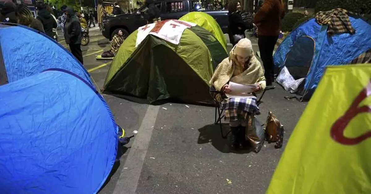 Protesters in Georgia's capital set up a tent camp on the main street and call for new elections