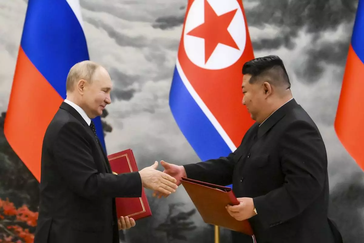 FILE - Russian President Vladimir Putin and North Korean leader Kim Jong Un exchange documents during a signing ceremony of a new partnership in Pyongyang, North Korea, on June 19, 2024. (Kristina Kormilitsyna, Sputnik, Kremlin Pool Photo via AP, File)