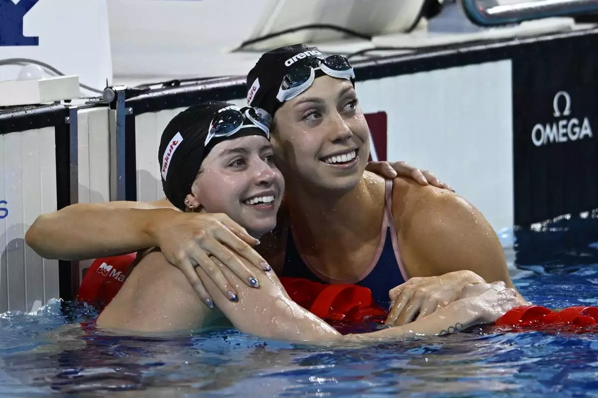 Second-placed Kate Douglass, left, and first-placed Gretchen Walsh, both from the United States, look at the scoreboard after the 50-meter freestyle al at the World Short Course Swimming Championships in Budapest, Hungary, Sunday, Dec. 15, 2024. (AP Photo/Denes Erdos)