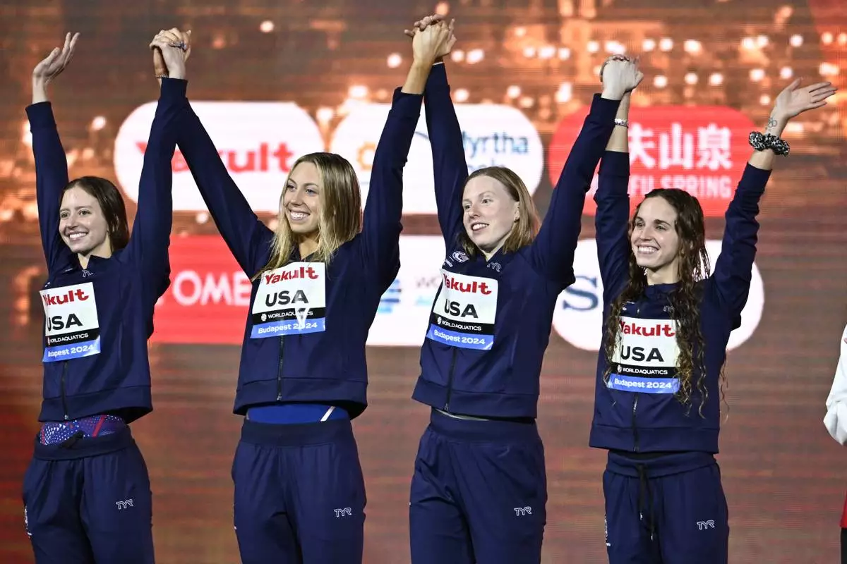 Team USA stands on the podium after winning the 4x100 medley relay final at the World Short Course Swimming Championships in Budapest, Hungary, Sunday, Dec. 15, 2024. (AP Photo/Denes Erdos)