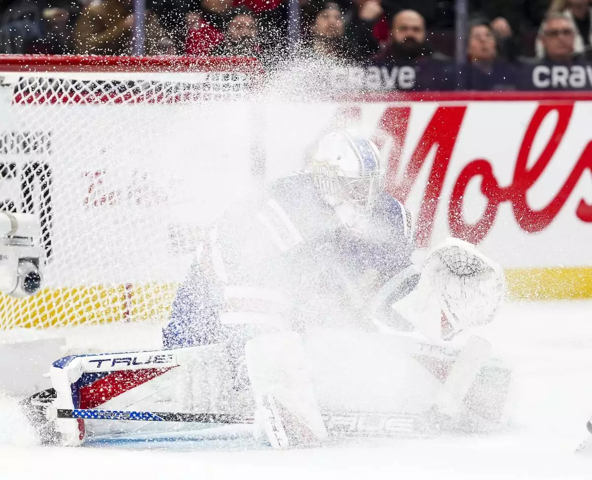 United States goaltender Trey Augustine is sprayed with ice from a skate blade while taking on Finland during second-period IIHF World Junior Hockey Championship tournament game action in Ottawa, Ontario, Sunday, Dec. 29, 2024. (Sean Kilpatrick/The Canadian Press via AP)