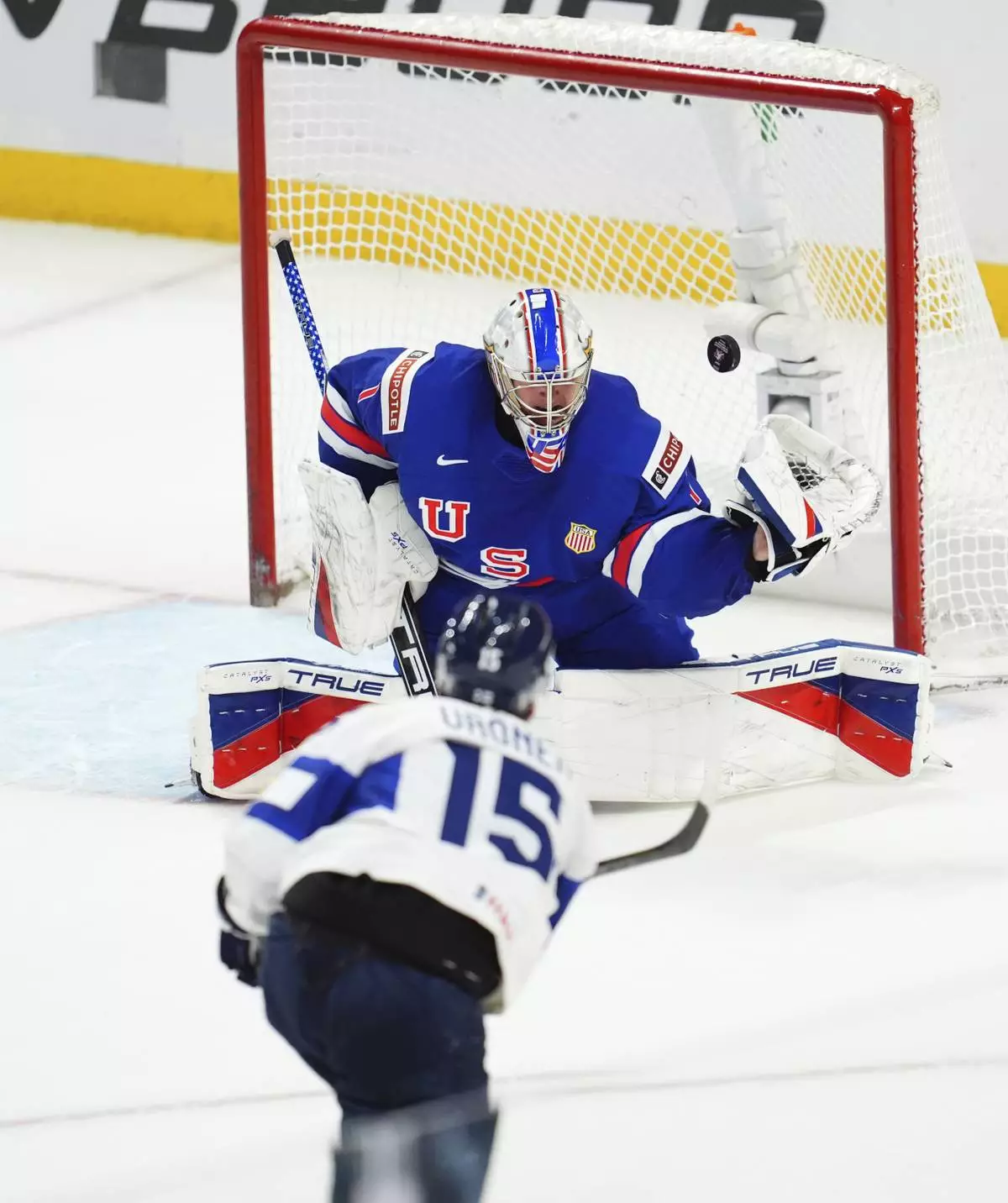 Finland forward Tuomas Uronen (15) scores the overtime winning goal against United States goaltender Trey Augustine (1) during IHF World Junior Hockey Championship tournament game action in Ottawa, Ontario, Sunday, Dec. 29, 2024. (Sean Kilpatrick/The Canadian Press via AP)