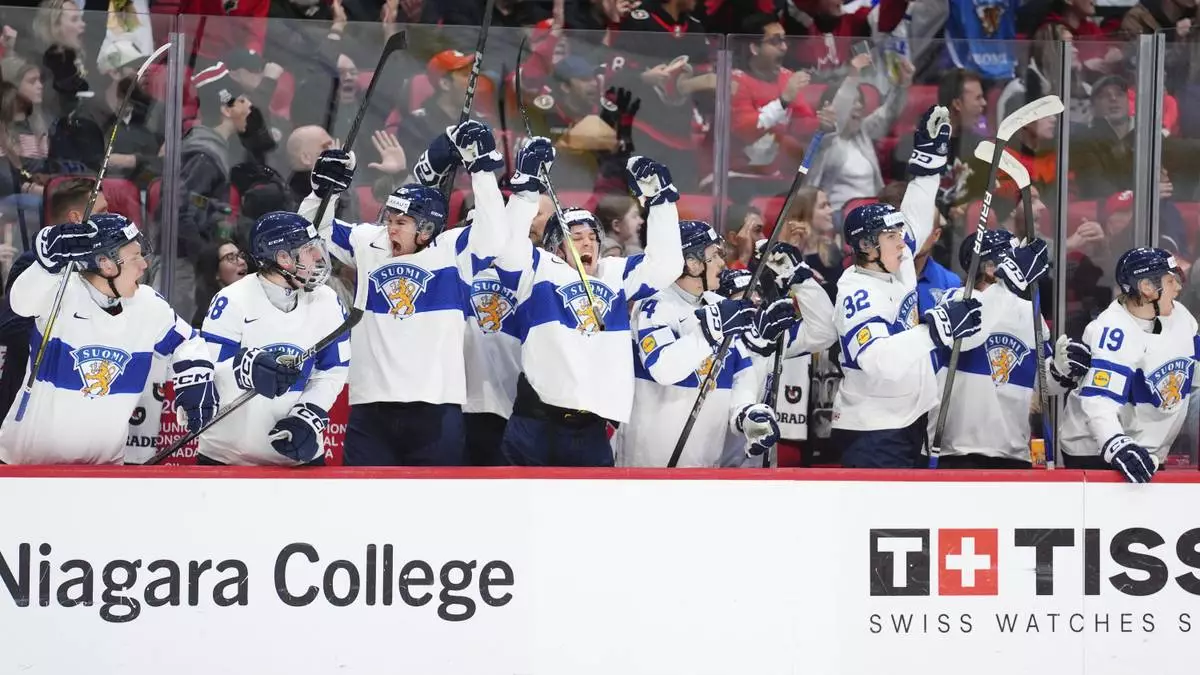 The players on the Finland bench celebrate after a goal by teammate Arttu Alasiurua against the United States during first-period IIHF World Junior Hockey Championship tournament game action in Ottawa, Ontario, Sunday, Dec. 29, 2024. (Sean Kilpatrick/The Canadian Press via AP)