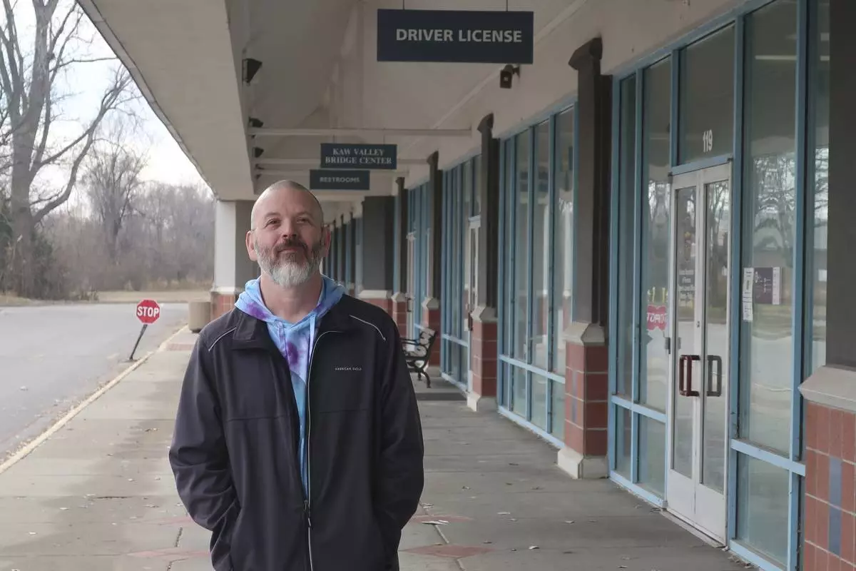 Steven Fish, of Garnett, Kan., stands outside a driver’s license office like one in the same strip mall where in 2014 he went to register to vote, Monday, Dec. 9, 2024, in Lawrence, Kan. Fish was unable to register in 2014 because he didn’t have an acceptable copy of his birth certificate to comply with a proof-of-citizenship law that was later struck down by the federal courts. (AP Photo/John Hanna)