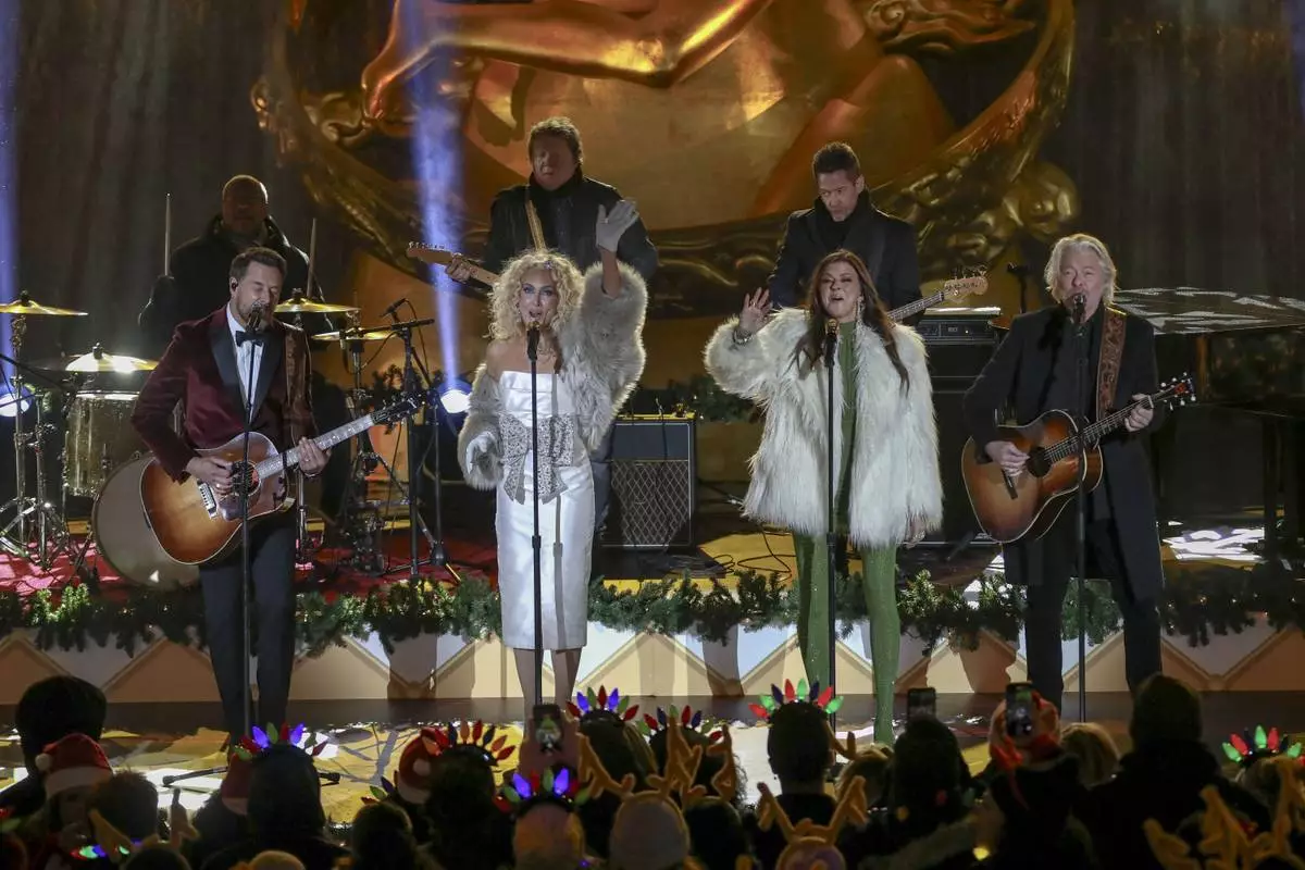 Jimi Westbrook, from left, Kimberly Schlapman, Karen Fairchild and Philip Sweet of Little Big Town participate in the Rockefeller Center Christmas tree lighting ceremony on Wednesday, Dec. 4, 2024, in New York. (Photo by Andy Kropa/Invision/AP)