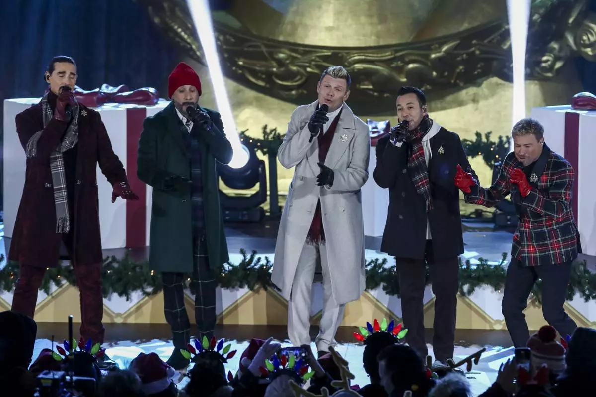 Singers Kevin Richardson, from left, AJ McLean, Nick Carter, Howie Dorough and Brian Littrell of the Backstreet Boys participate in the Rockefeller Center Christmas tree lighting ceremony on Wednesday, Dec. 4, 2024, in New York. (Photo by Andy Kropa/Invision/AP)