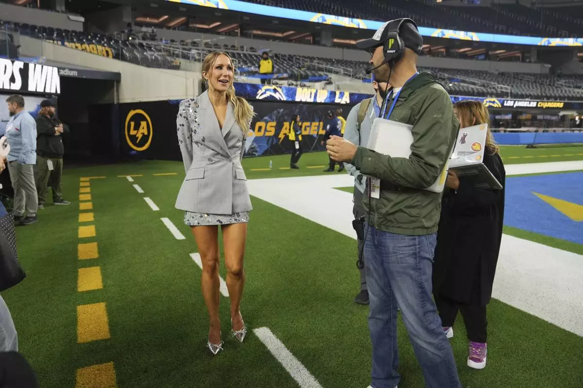 Nikki Glaser stands on the field after NFL football game between the Los Angeles Chargers and the Denver Broncos, Thursday, Dec. 19, 2024, in Inglewood, Calif. (AP Photo/Eric Thayer)