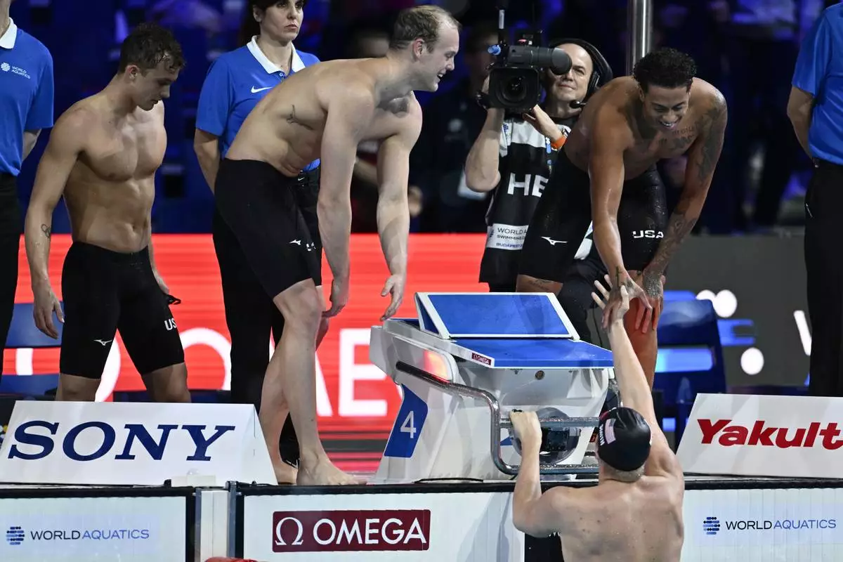 Team USA celebrates after they won the 4x200-meter freestyle relay at the World Short Course Swimming Championships in Budapest, Hungary, on Friday, Dec. 13, 2024. (AP Photo/Denes Erdos)