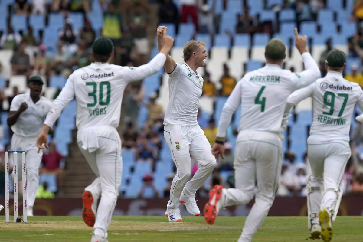 South Africa's Corbin Bosch, centre, celebrates with teammates after taking a wicket of Pakistan's Shan Masood for 17 runs during day one of the Test cricket match between South Africa and Pakistan, at the Centurion Park in Centurion, South Africa, Thursday, Dec. 26, 2024. (AP Photo/Themba Hadebe)