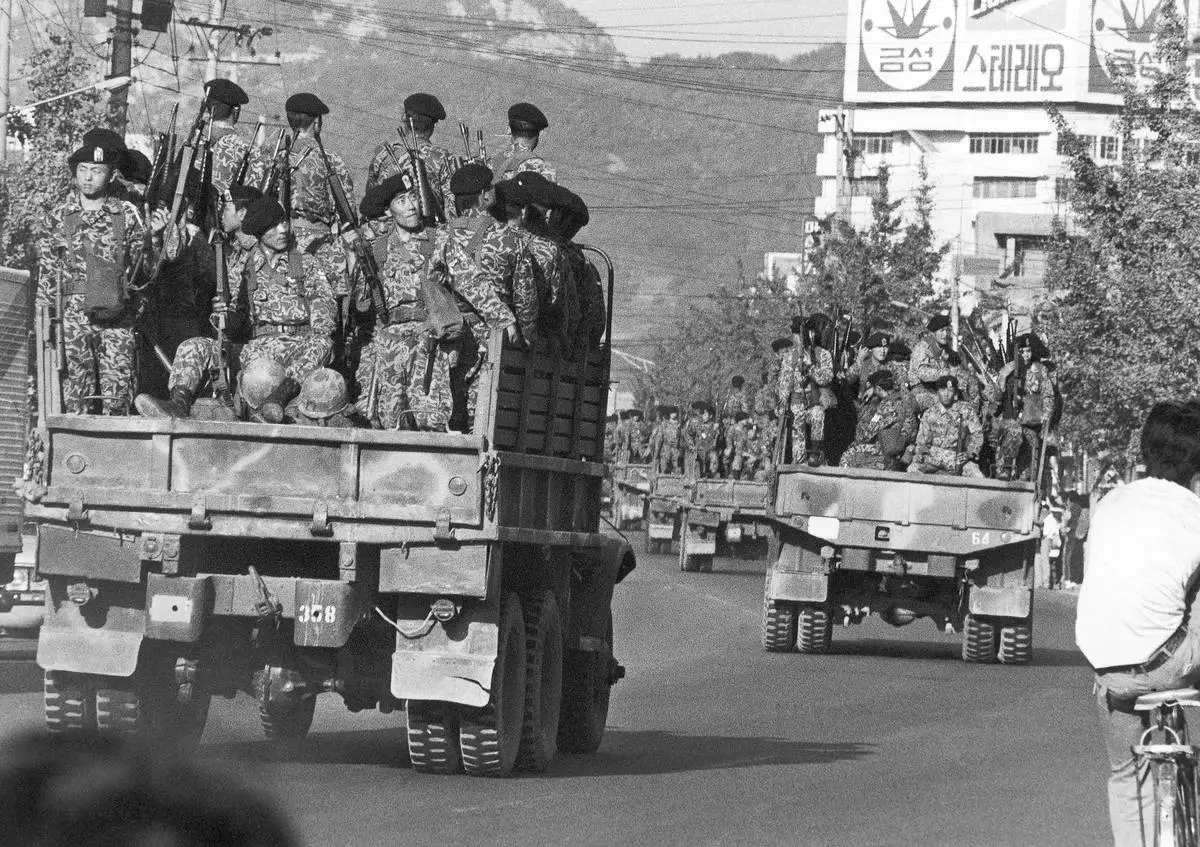 FILE- Truckloads of South Korean paratroopers move in downtown Masan on Oct. 20, 1979 as a "garrison decree" was proclaimed following two days of rioting against the government in this south coast city, 300 km south of Seoul, South Korea. (AP Photo/Kim Chon-Kil, File)