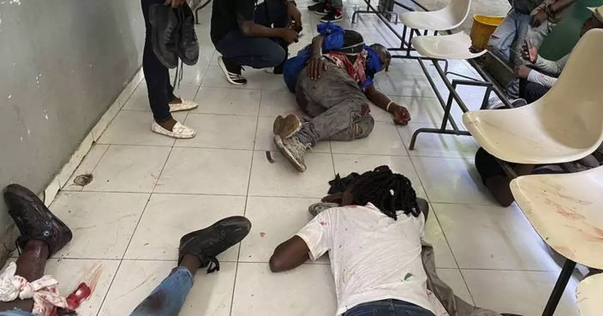 A Haiti gang attack on the reopening of a main hospital kills 2 reporters and a police officer