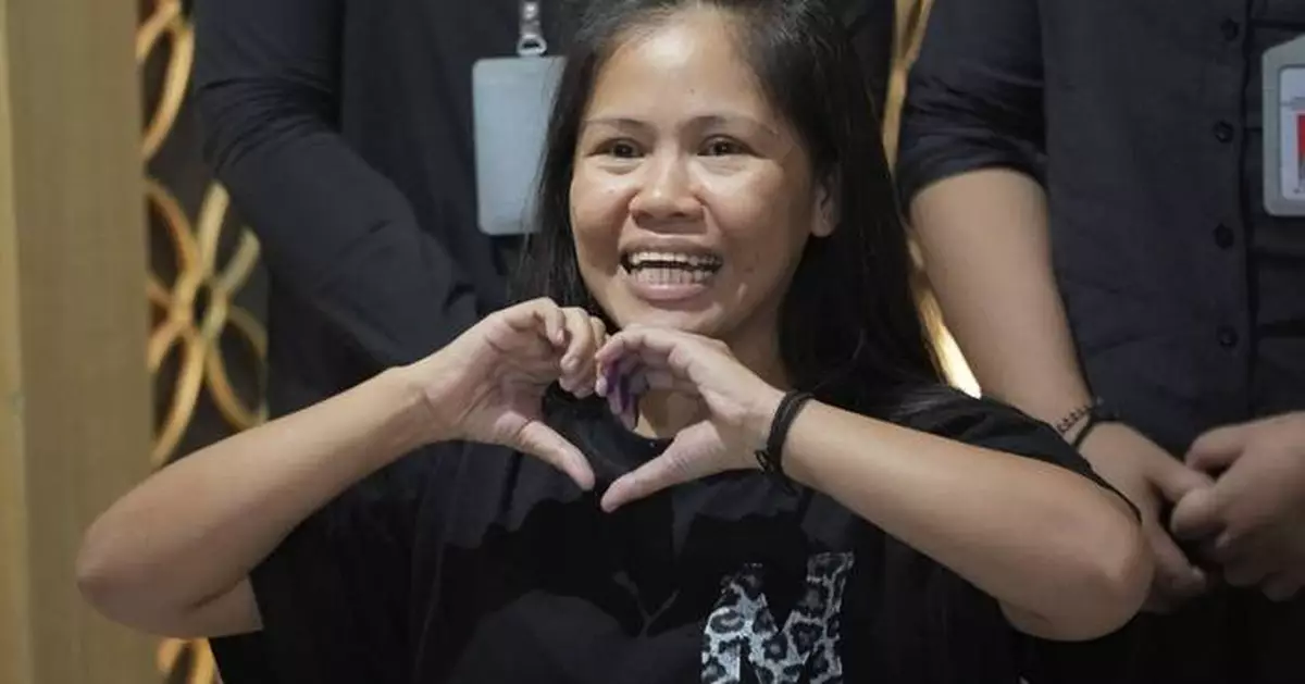 Filipina who won a last-minute reprieve from an Indonesian firing squad returns home