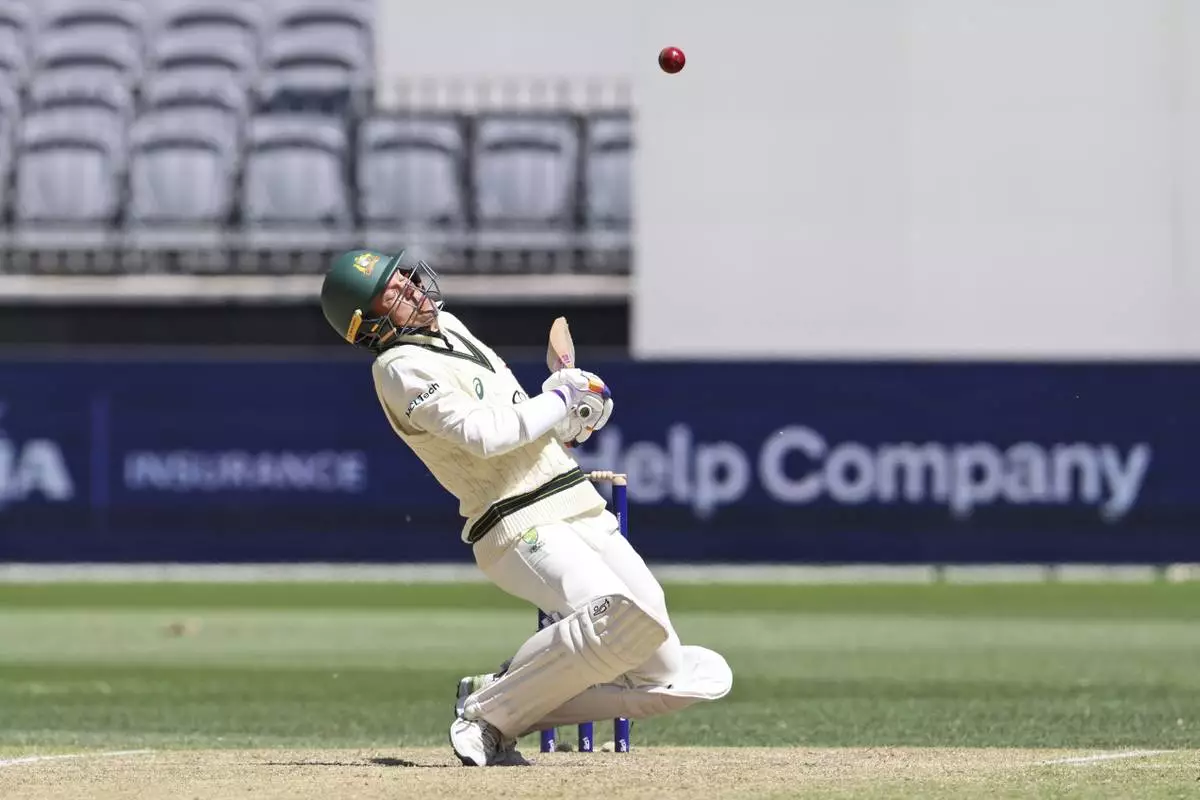 Australia's Alex Carey ducks to avoid a bouncer from India's captain Jasprit Bumrah on the fourth day of the first cricket test between Australia and India in Perth, Australia, Monday, Nov. 25, 2024. (AP Photo/Trevor Collens)