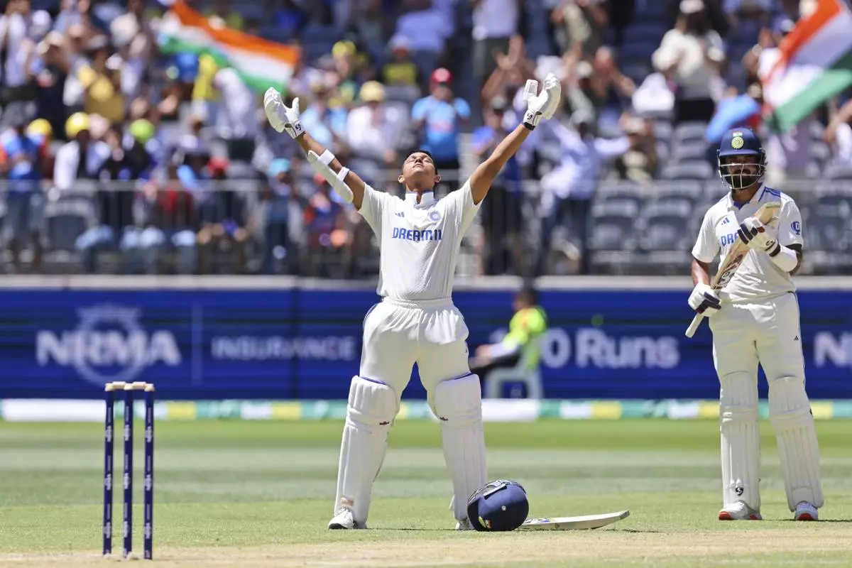 India's Yashasvi Jaiswal, left, celebrates his century as teammate India's KL Rahul applauds on the third day of the first cricket test between Australia and India in Perth, Australia, Sunday, Nov. 24, 2024. (AP Photo/Trevor Collens)