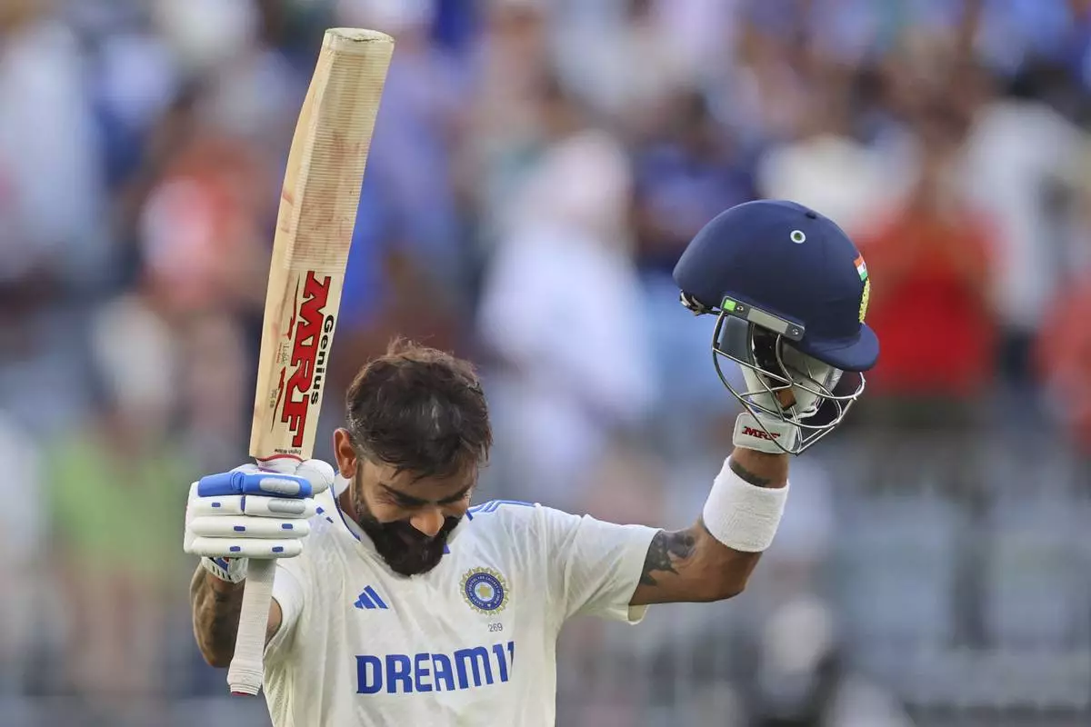 India's Virat Kohli celebrates his century on the third day of the first cricket test between Australia and India in Perth, Australia, Sunday, Nov. 24, 2024. (AP Photo/Trevor Collens)