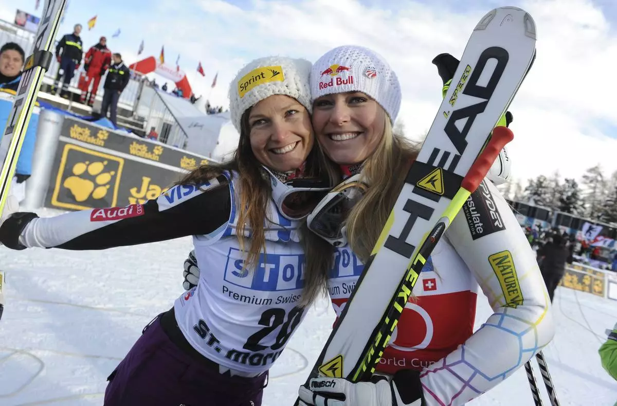 FILE - In this Dec. 8, 2012, file photo, Lindsey Vonn, right, celebrates with third-placed Julia Mancuso after winning an alpine ski, women's World Cup super-G, in St. Moritz, Switzerland. (AP Photo/Giovanni Auletta, File)