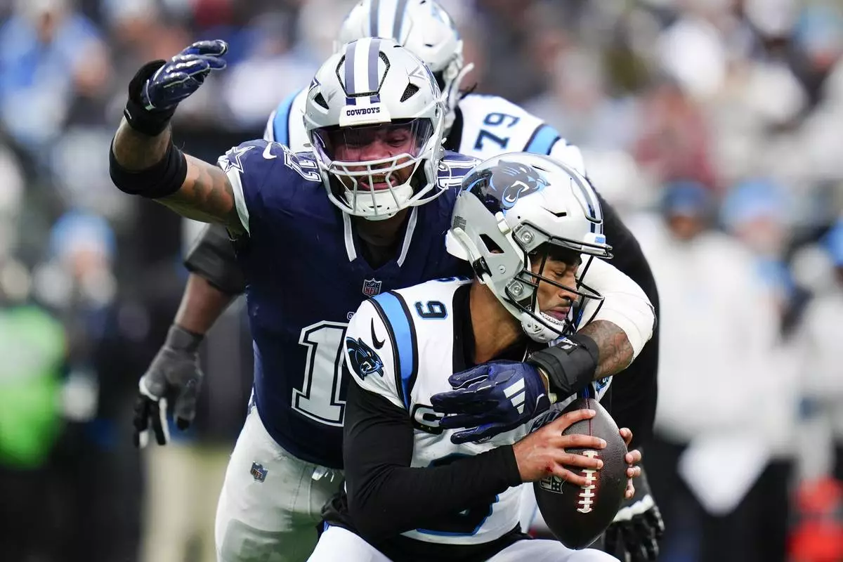 Dallas Cowboys linebacker Micah Parsons sacks Carolina Panthers quarterback Bryce Young during the second half of an NFL football game, Sunday, Dec. 15, 2024, in Charlotte, N.C. (AP Photo/Rusty Jones)