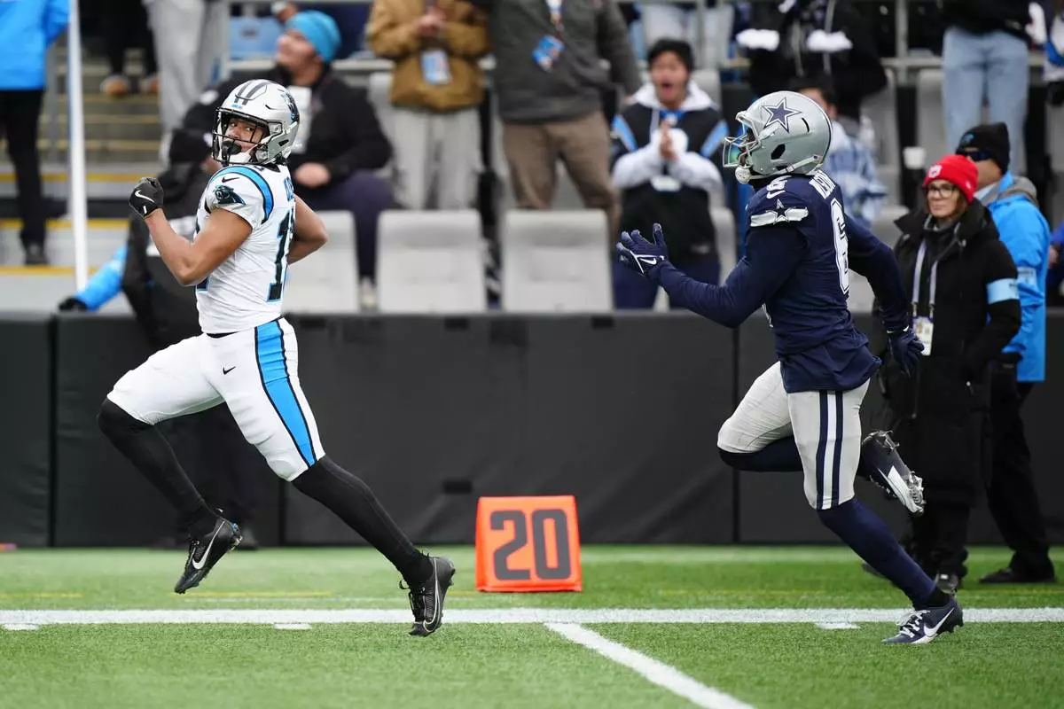 Carolina Panthers wide receiver Jalen Coker (18) runs for a touchdown against the Dallas Cowboys during the first half of an NFL football game, Sunday, Dec. 15, 2024, in Charlotte, N.C. (AP Photo/Jacob Kupferman)