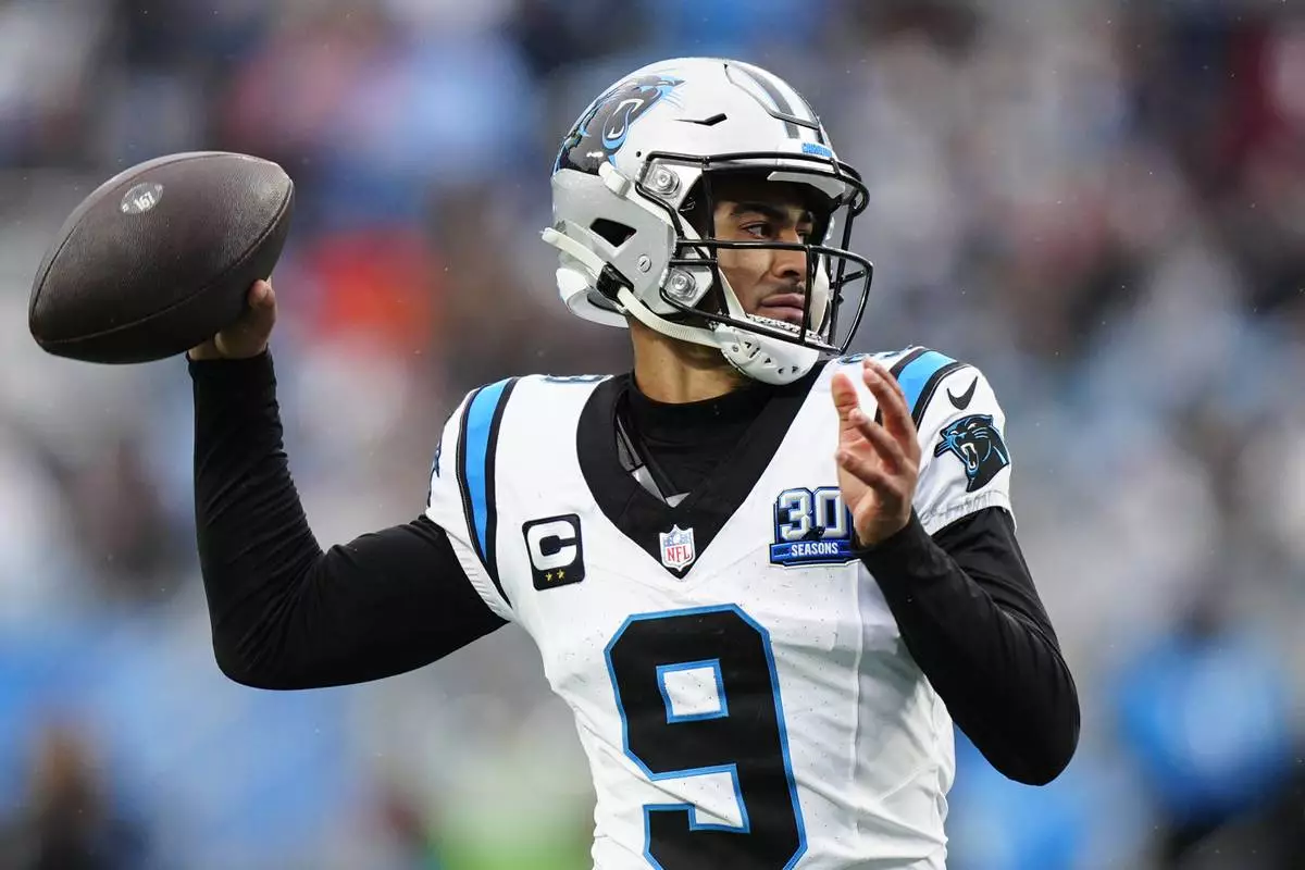 Carolina Panthers quarterback Bryce Young passes against the Dallas Cowboys during the second half of an NFL football game, Sunday, Dec. 15, 2024, in Charlotte, N.C. (AP Photo/Jacob Kupferman)