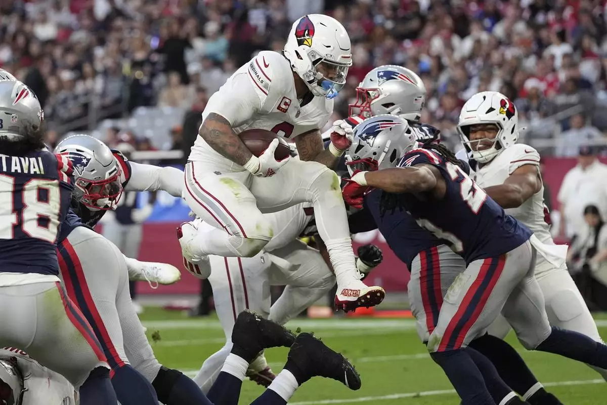 Arizona Cardinals running back James Conner (6) scores a touchdown against the New England Patriots during the second half of an NFL football game, Sunday, Dec. 15, 2024, in Glendale, Ariz. (AP Photo/Ross D. Franklin)