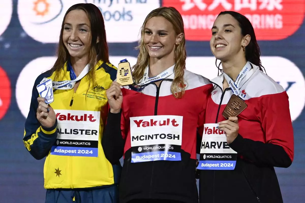 From the left, second-placed Lani Pallister of Australia, first-placed Canada's Summer Mcintosh, and third-placed Canada's Mary-Sophie Harvey during the World Short Course Swimming Championships in Budapest, Hungary, Tuesday, Dec. 10, 2024. (AP Photo/Denes Erdos)