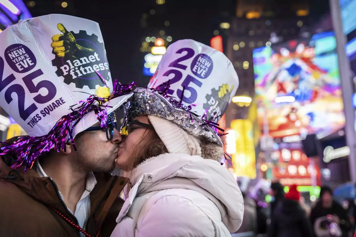 A couple kiss after the ball drops in New York's Times Square, Wednesday, Jan. 1, 2025, in New York. (AP Photo/Stefan Jeremiah)