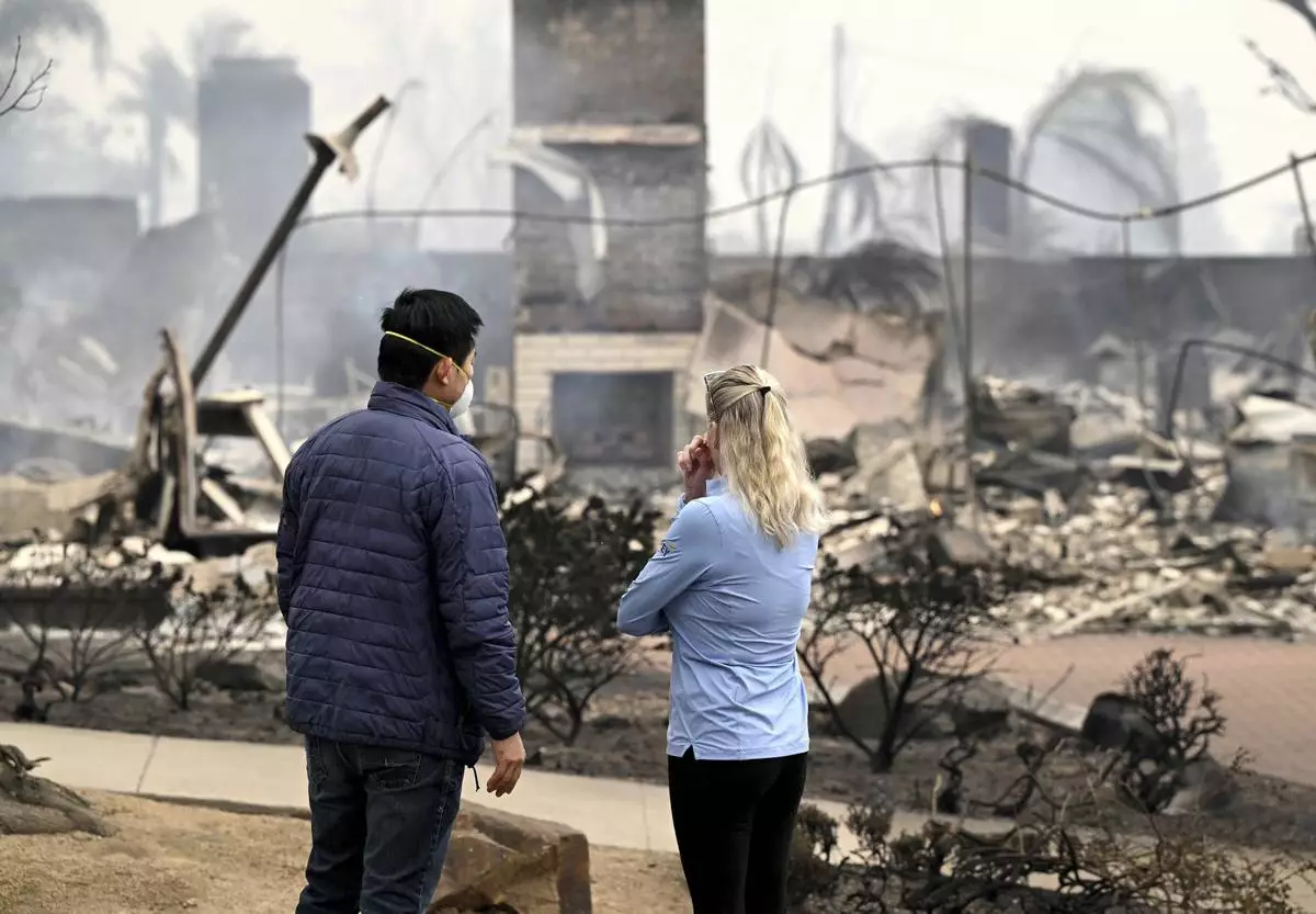 Hastings Ranch resident Patricia Vahdat, right, and a neighbor speak in front of another one of her neighbors home which was completely destroyed by the Eaton fire in the Hastings Ranch community of Pasadena early Wednesday morning Jan. 8, 2025.(Will Lester/The Orange County Register via AP)