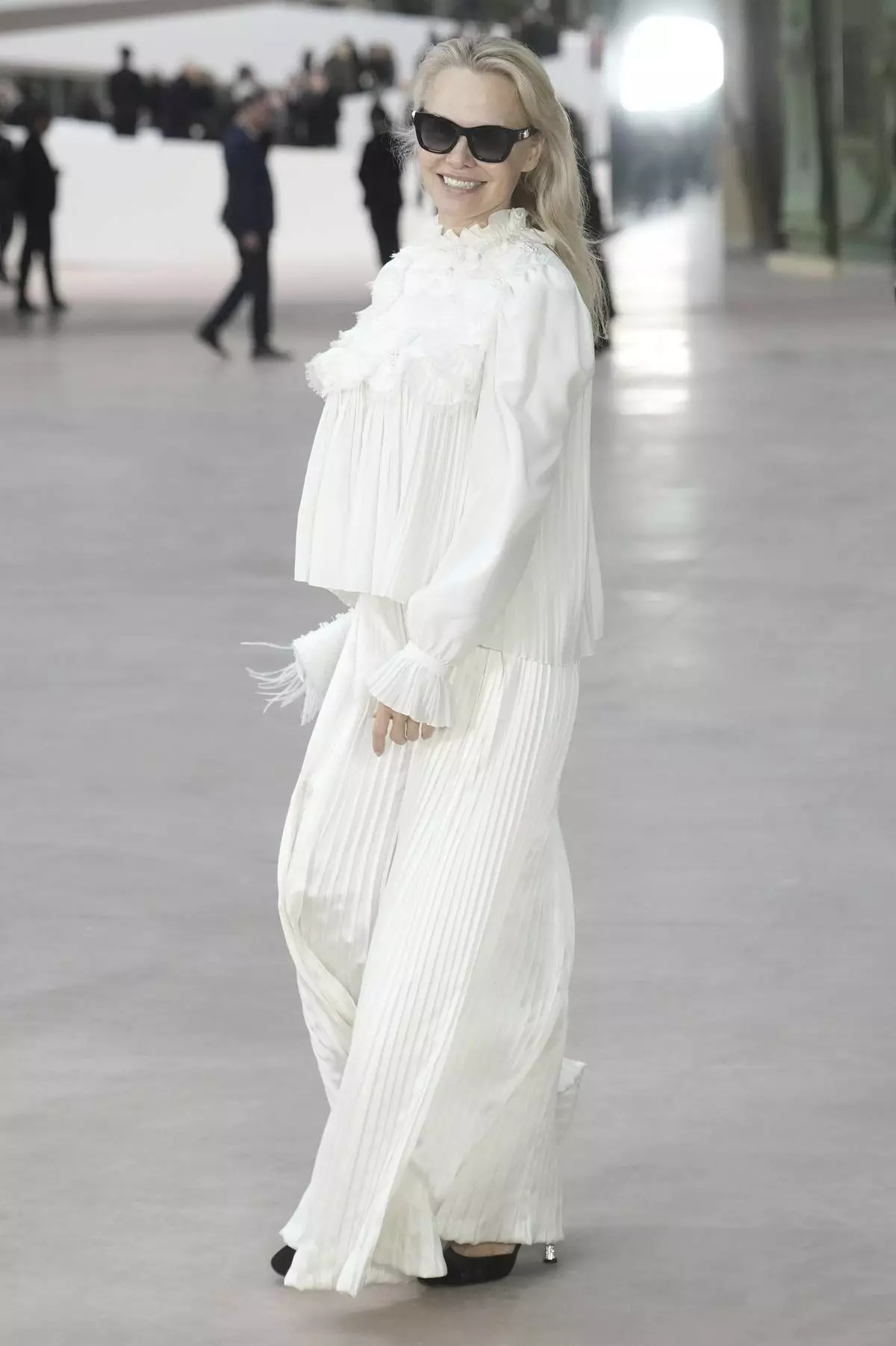 Pamela Anderson arrives at the Chanel Haute Couture Spring Summer 2025 collection, to be presented in Paris, Tuesday, Jan. 28, 2025. (AP Photo/Thibault Camus)