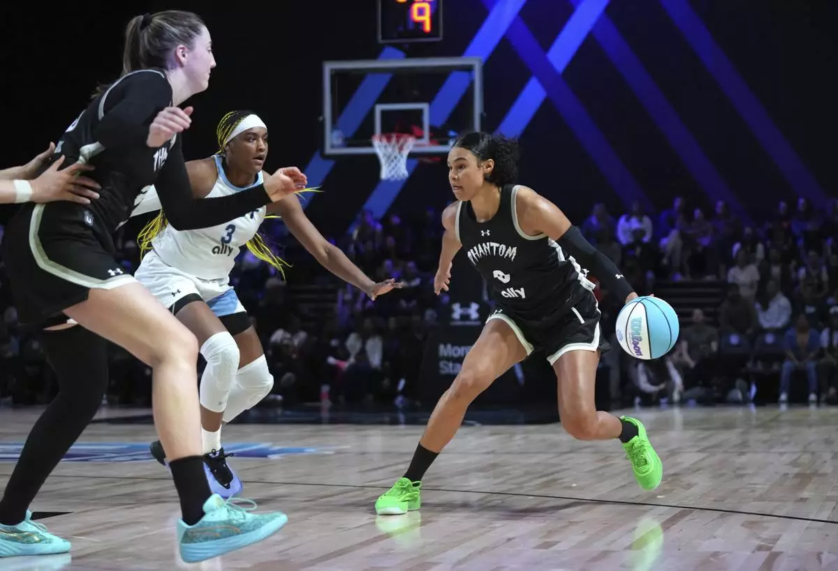 Phantom forward Satou Sabally (0) drives to the basket as Mist forward Aaliyah Edwards (3) defends during the second half of an Unrivaled 3-on-3 basketball game Friday, Jan. 24, 2025, in Medley, Fla. (AP Photo/Lynne Sladky)