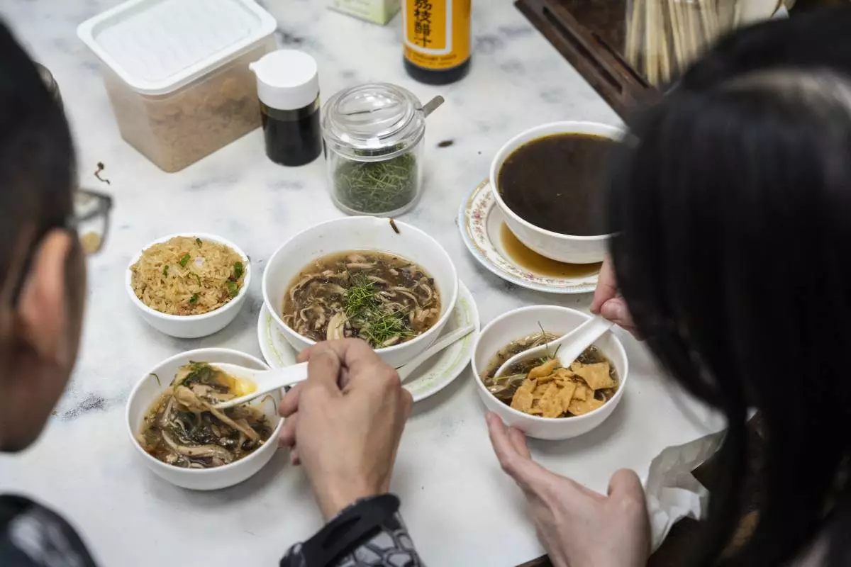 Customers dine at the family-run snake soup restaurant in Hong Kong, Monday, Jan. 6, 2025. (AP Photo/Chan Long Hei)