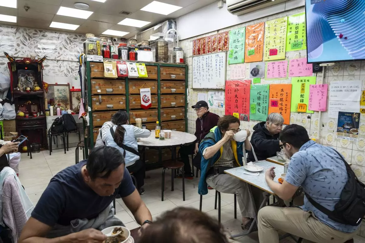 Customers dine at the family-run snake soup restaurant in Hong Kong, Monday, Jan. 6, 2025. (AP Photo/Chan Long Hei)