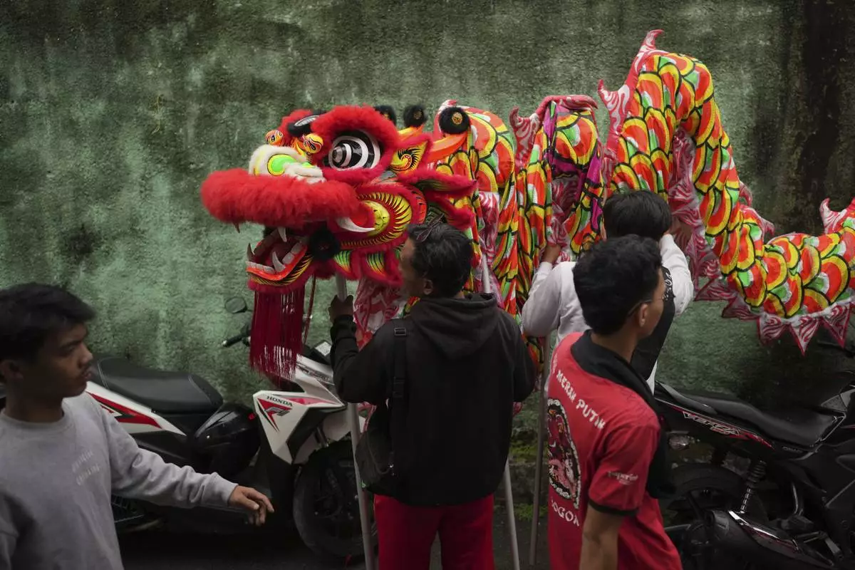 Members of dragon dance club Naga Merah Putih (Red White Dragon) which named after Indonesian national colors, prepare a dragon puppet before leaving for a shopping mall to perform in a Lunar New Year celebration, in Bogor, West Java, Indonesia, Sunday, Jan. 26, 2025. (AP Photo/Dita Alangkara)