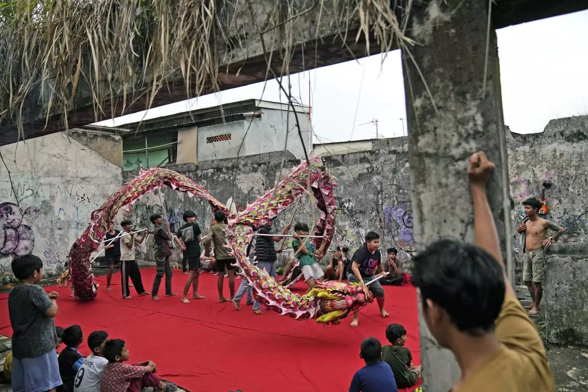 Members of dragon dance club Naga Merah Putih (Red White Dragon) which is named after Indonesian national colors, practice in Bogor, West Java, Indonesia, Wednesday, Jan. 22, 2025. (AP Photo/Dita Alangkara)